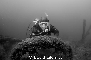 Diver poses at the fly wheel of pump in Sherkston Quarry. by David Gilchrist 